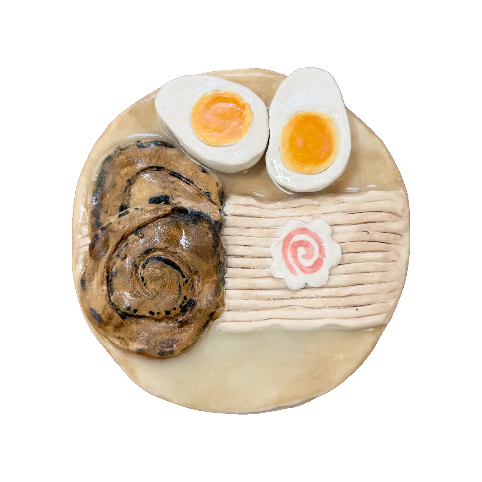 Ceramic plate of ramen toppings: sliced chashu pork, halved soft-boiled eggs, narutomaki fish cake and noodles