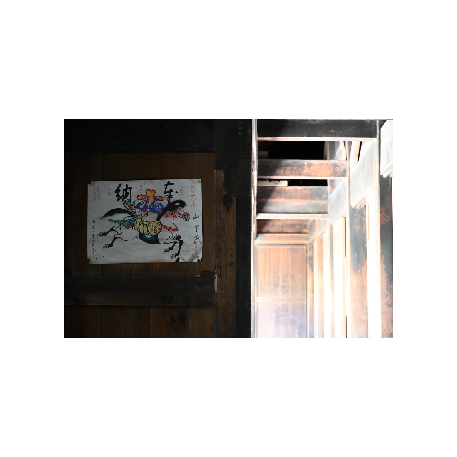 Painting of a galloping horse pinned to a dark wooden wall