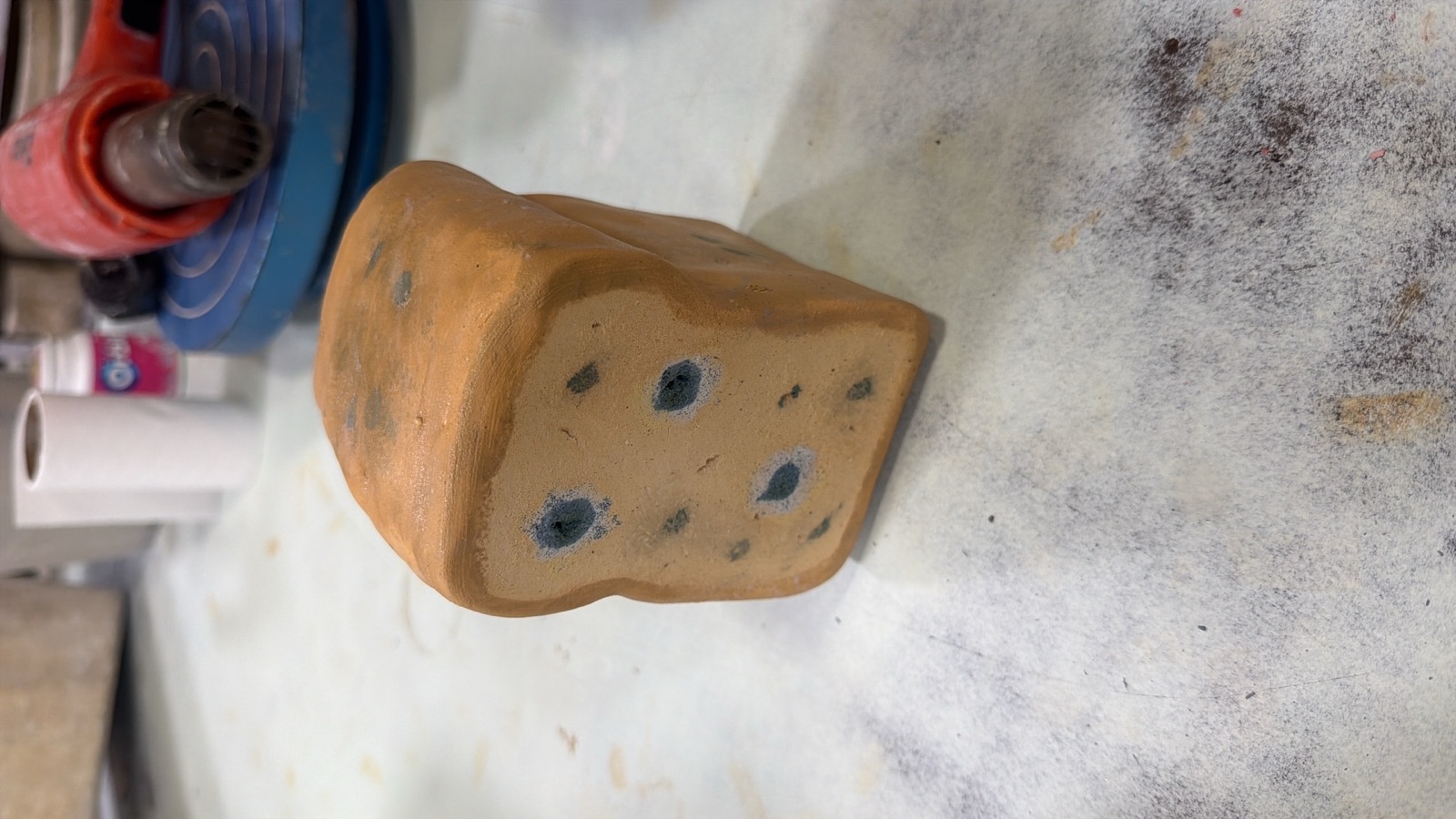 Ceramic loaf of bread with blue mold spots