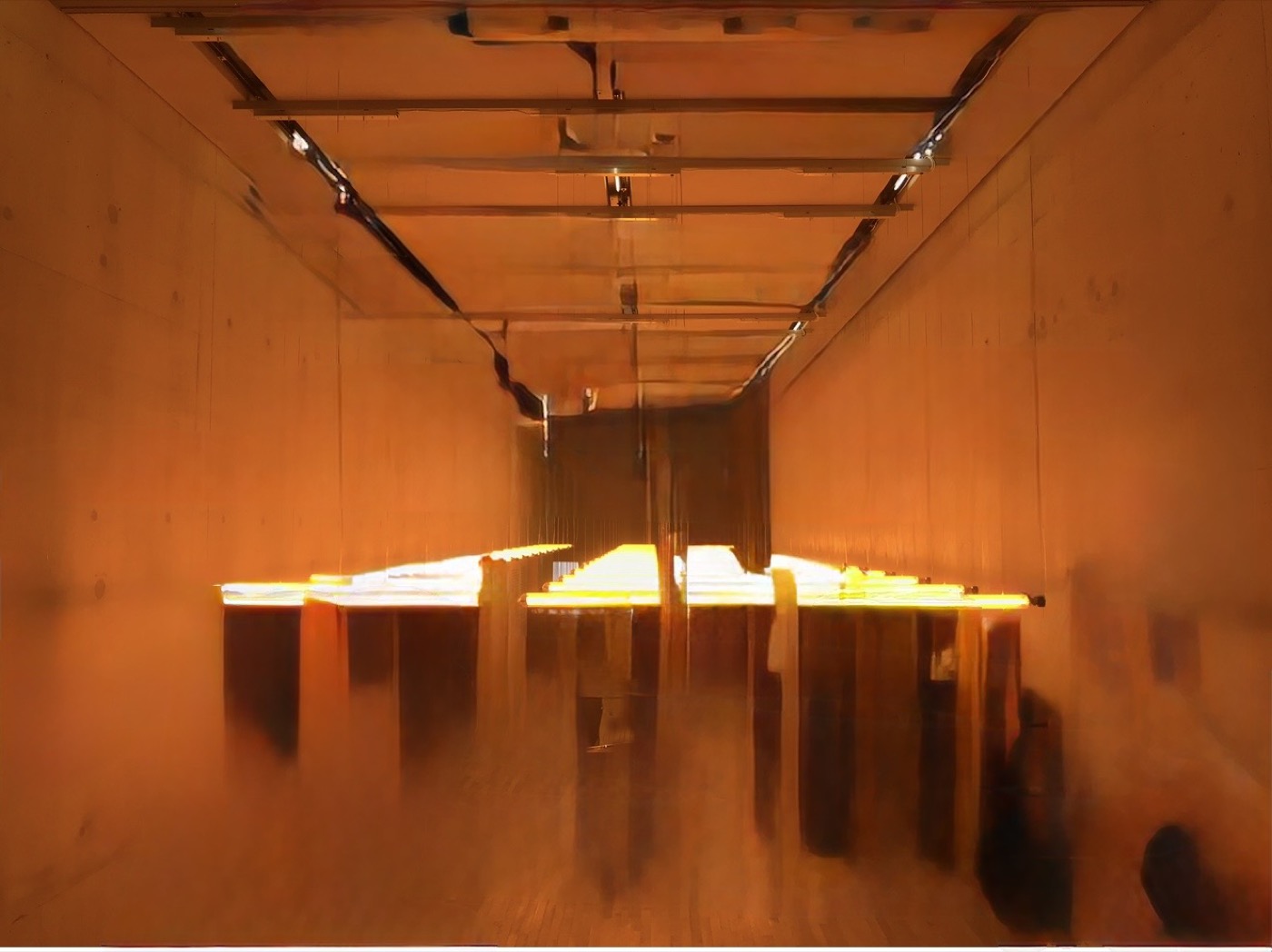 Edited photograph of a hazy orange hall with suspended glowing yellow light fixtures