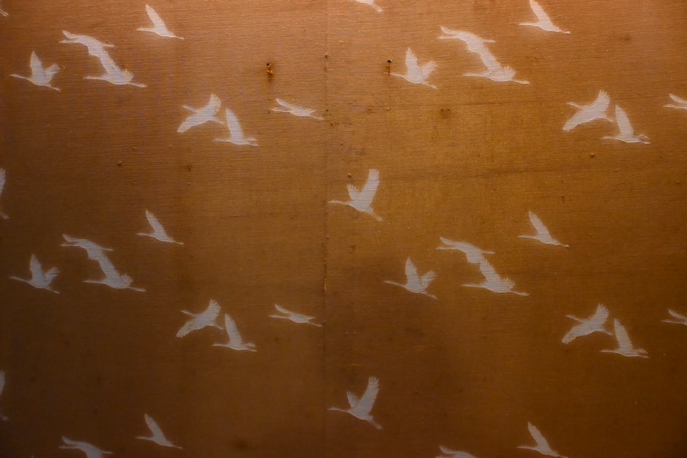 White cranes on golden-brown washi paper