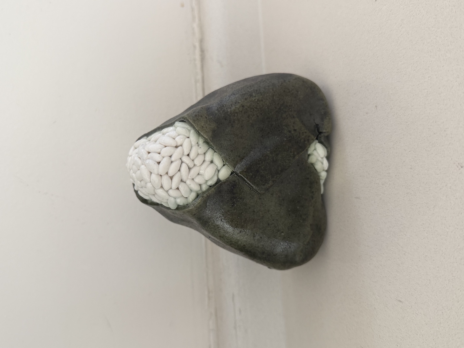 Ceramic onigiri, dark seaweed wrapping sculpted rice grains